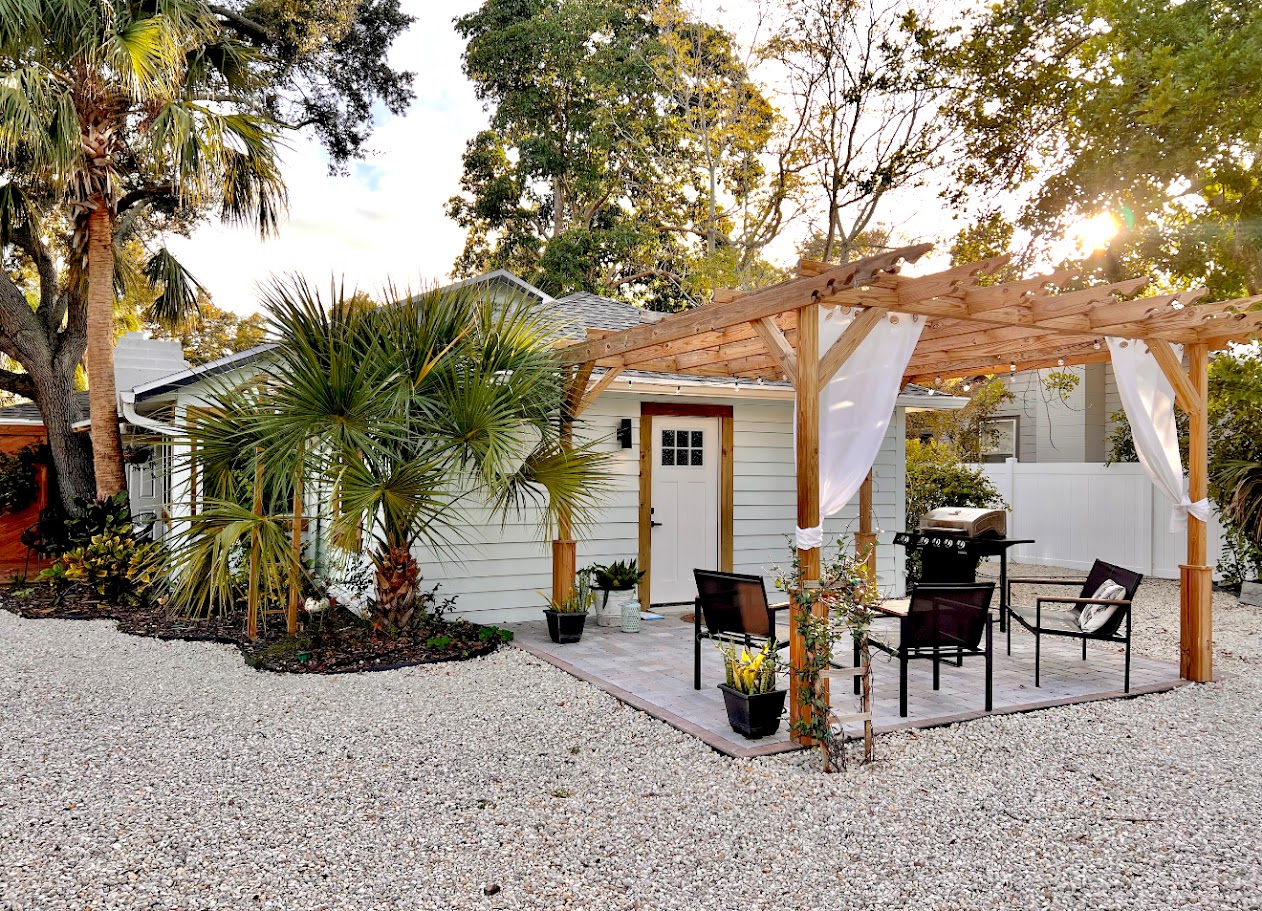 Backyard after — custom cedar pergola, patio, and landscaping by Madeira Studios