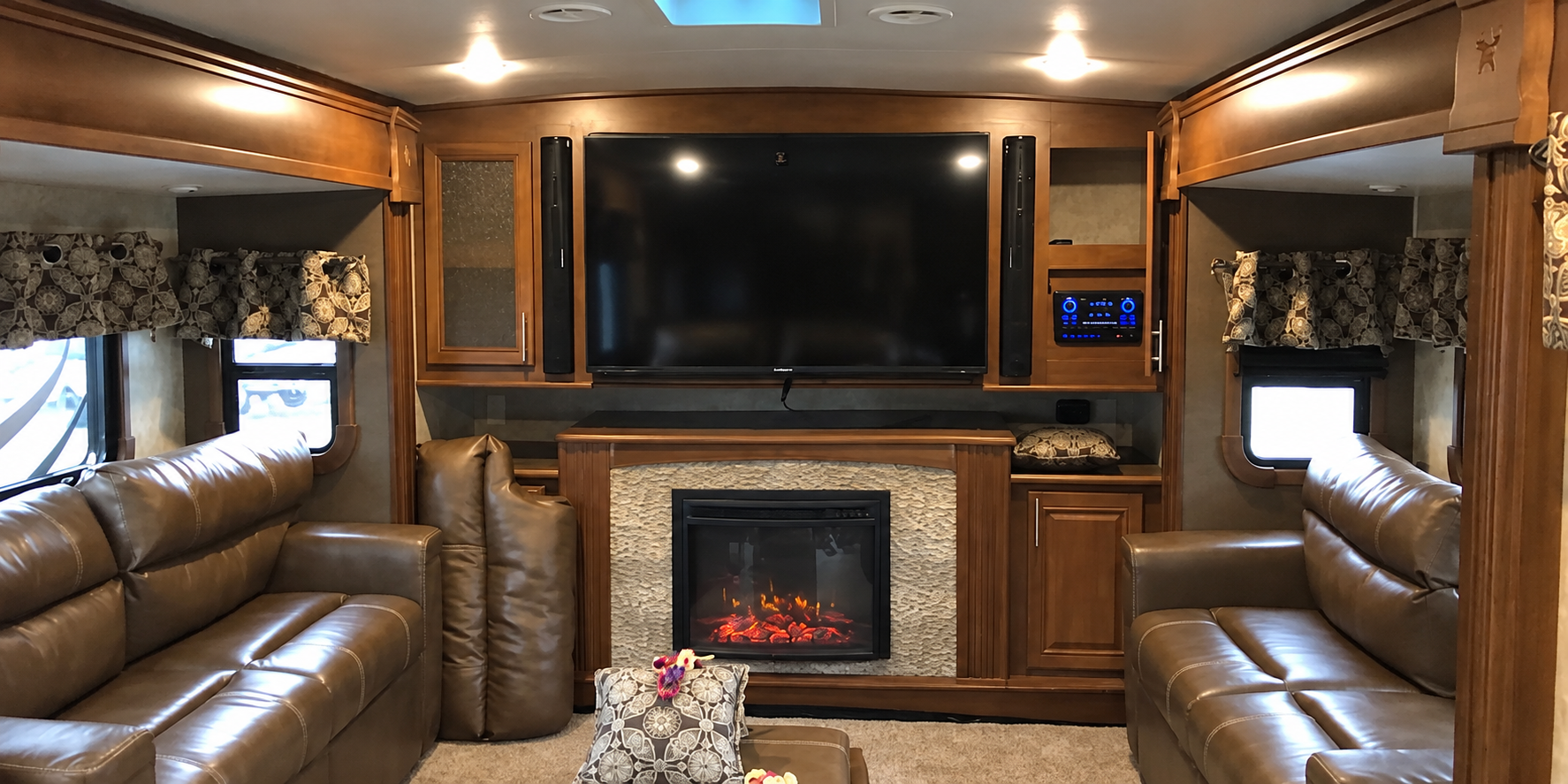 RV living area before renovation — original dark wood and leather seating