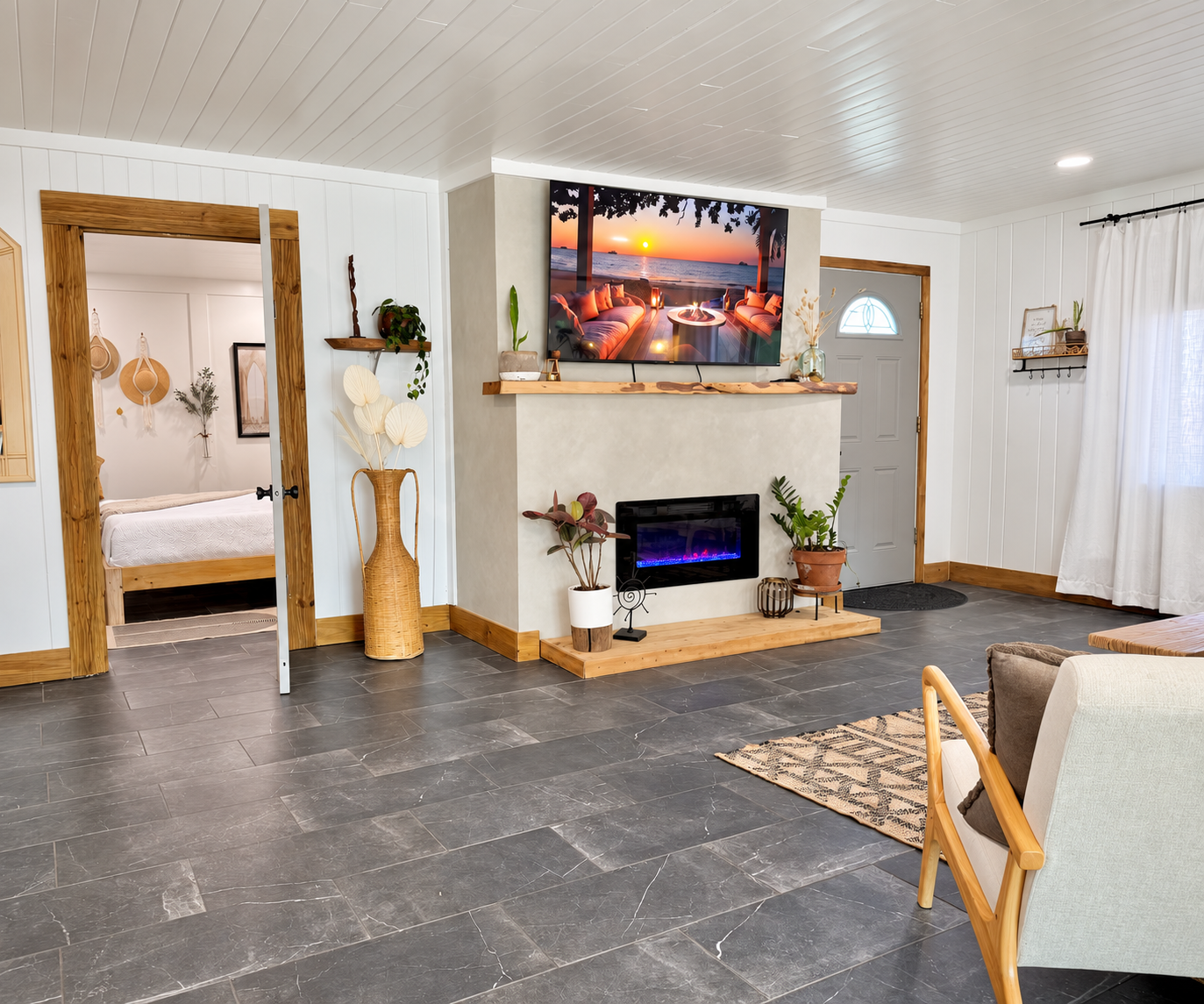 Living room after renovation by Madeira Studios — custom fireplace and door