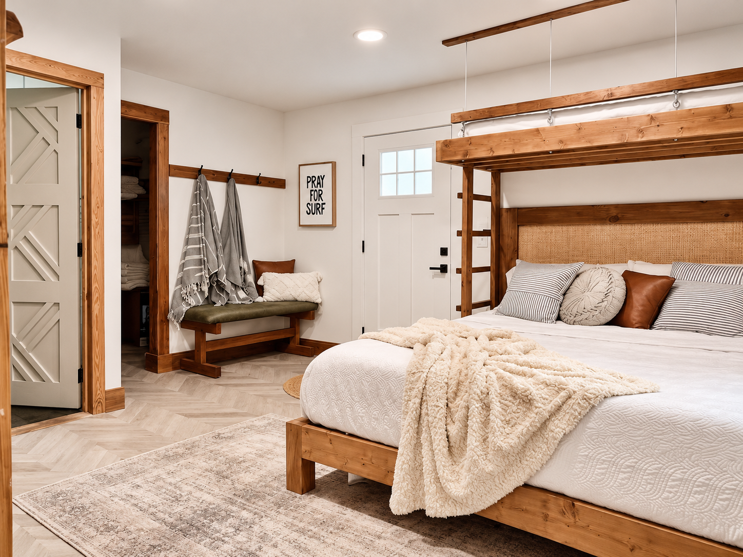 Bedroom after renovation by Madeira Studios — custom bed frame and door
