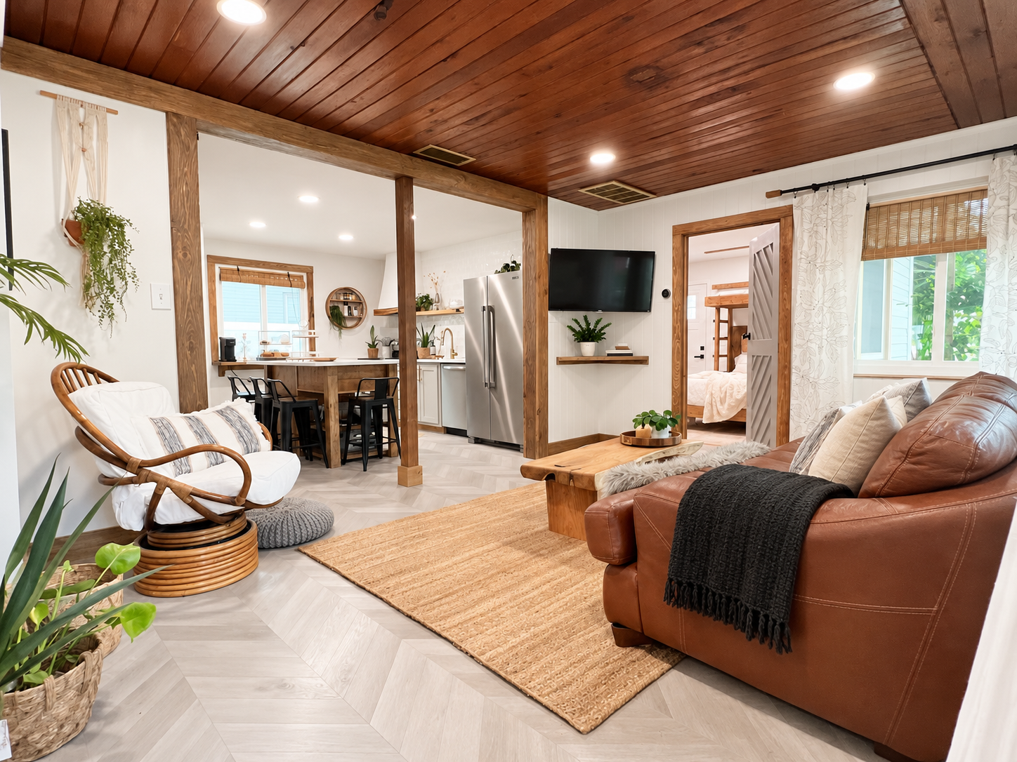 Family room after renovation by Madeira Studios — open living space with wood beams and custom finishes
