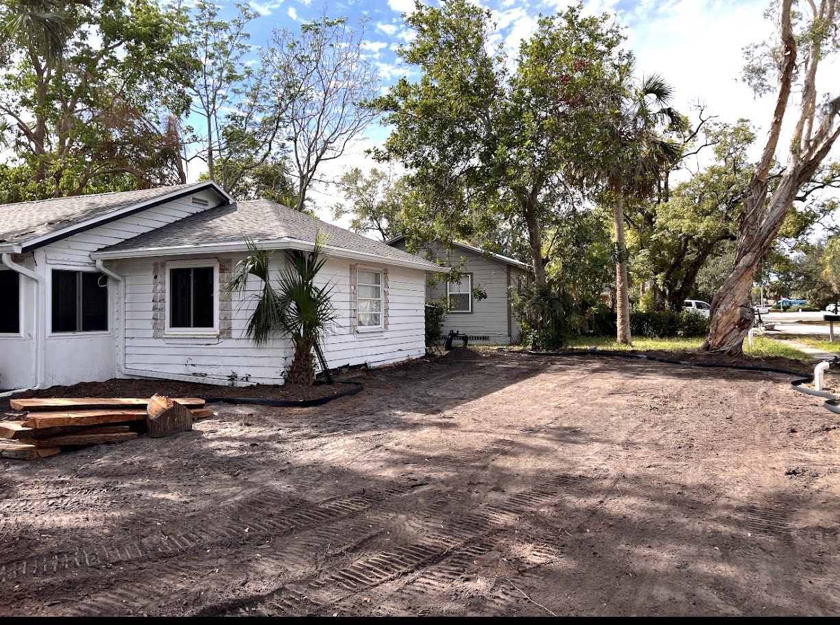 Backyard before — cleared side yard with original siding
